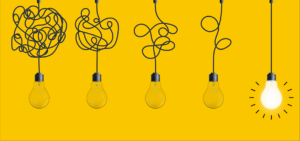 Lightbulbs hanging in a row. One is turned on.