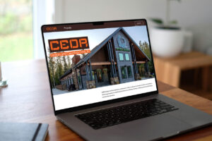 The CEDR website loaded onto a laptop sitting on a wooden desk