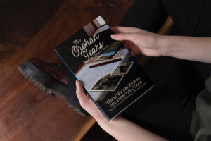A person holding a copy of The Orphan Years in their lap